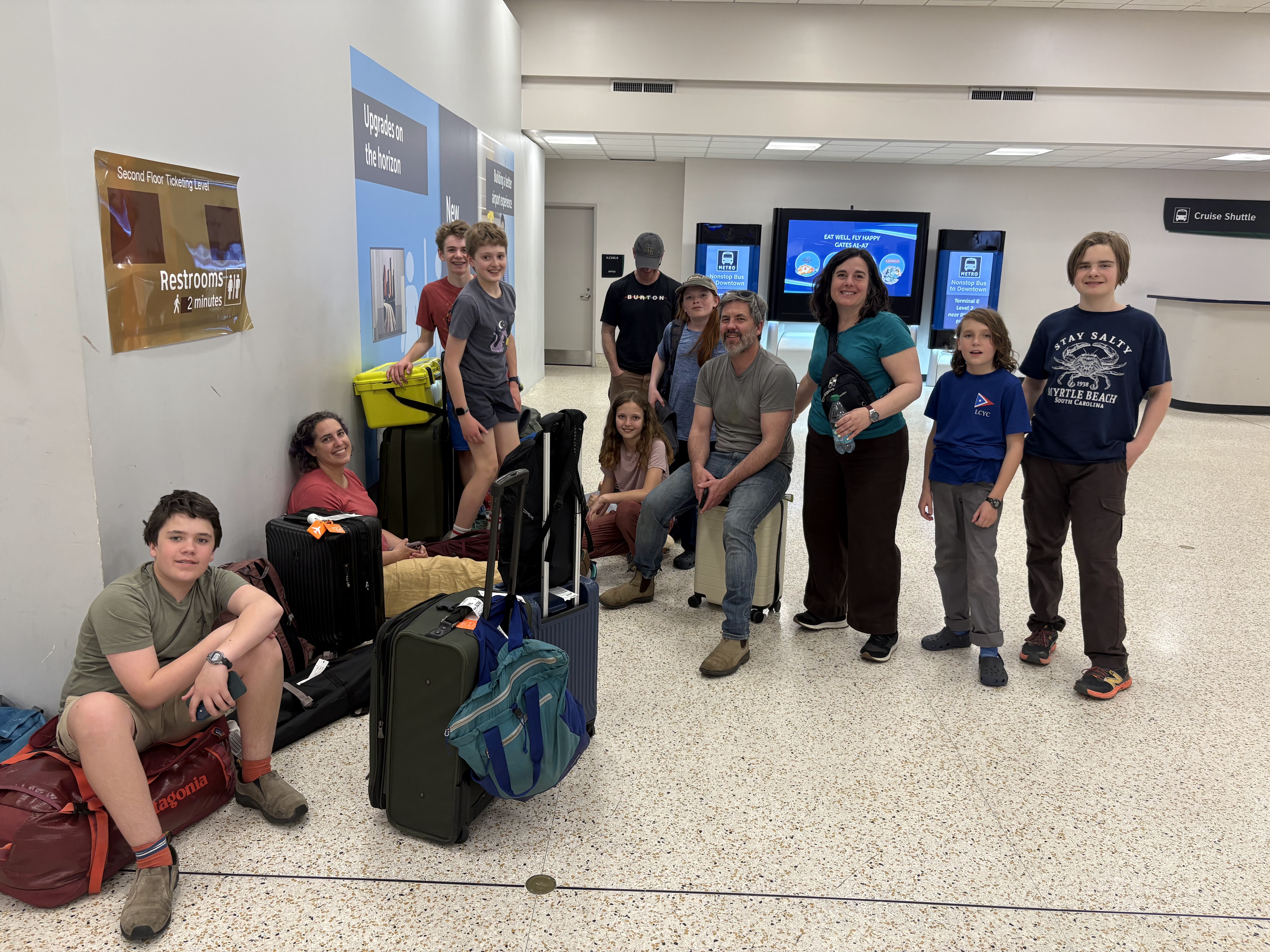 Team members and supporters arriving with their luggage