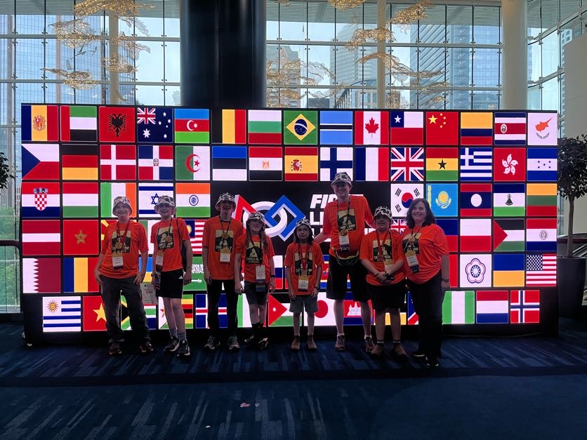 Camels Hump Coders in front of an international flags display